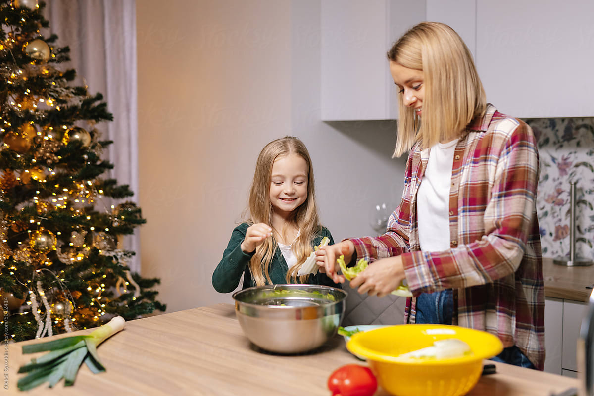 Kid mom meal cook Christmas eve home together happy