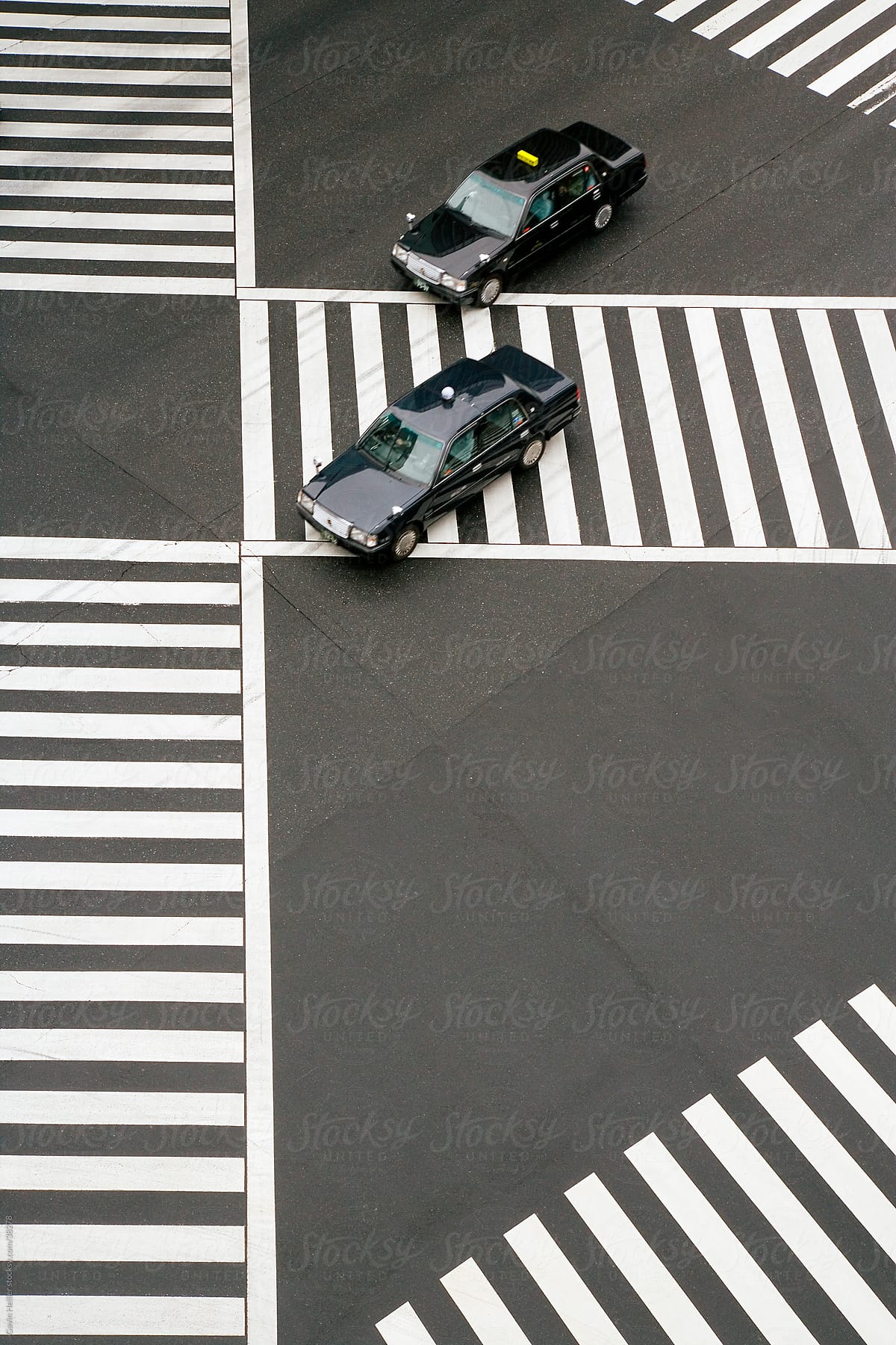 Asia, Japan, Honshu, Tokyo, Ginza, taxi cabs driving across Sukiyabashi Pedestrian Crossing - elevated view