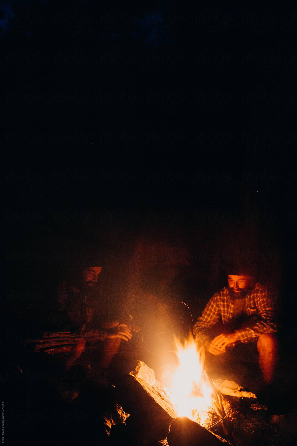 Long Exposure Image Of Man Duplicated By Campfire