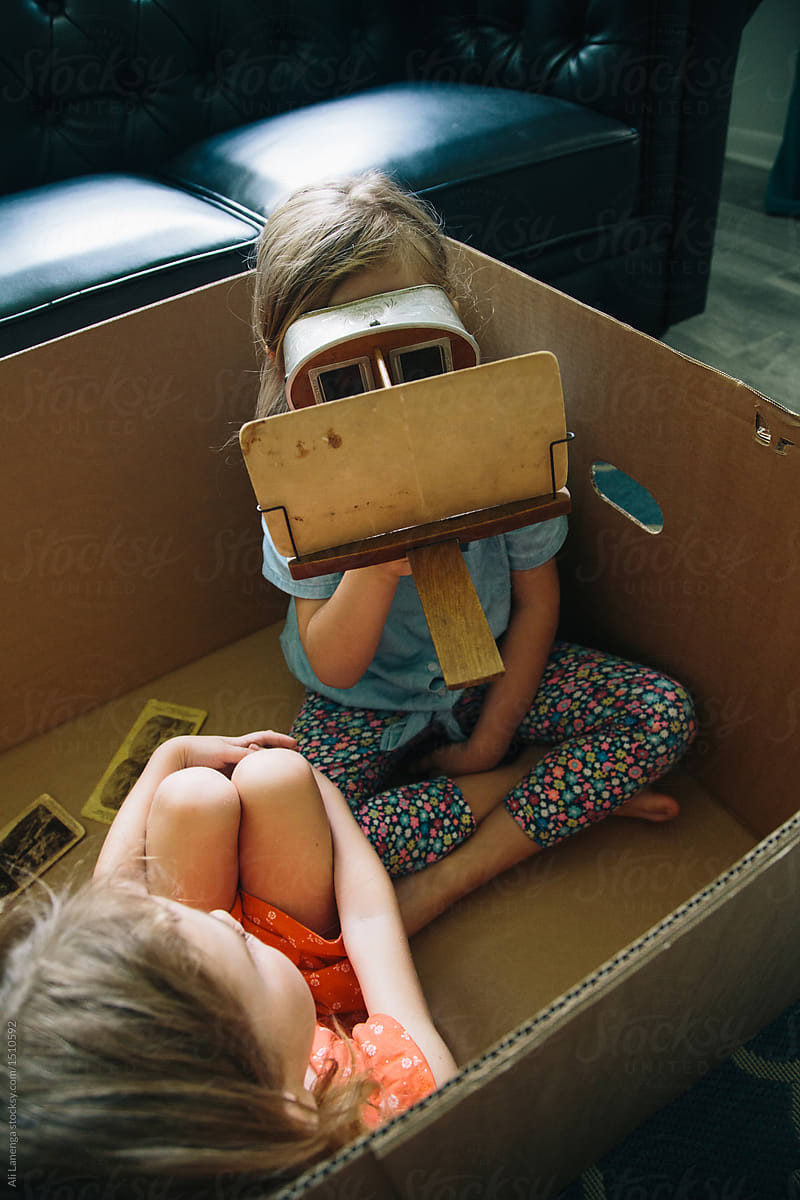 Sisters In A Cardboard Box with A Stereoscope