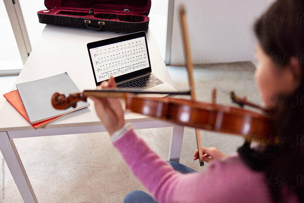 Female violinist during online lesson at home