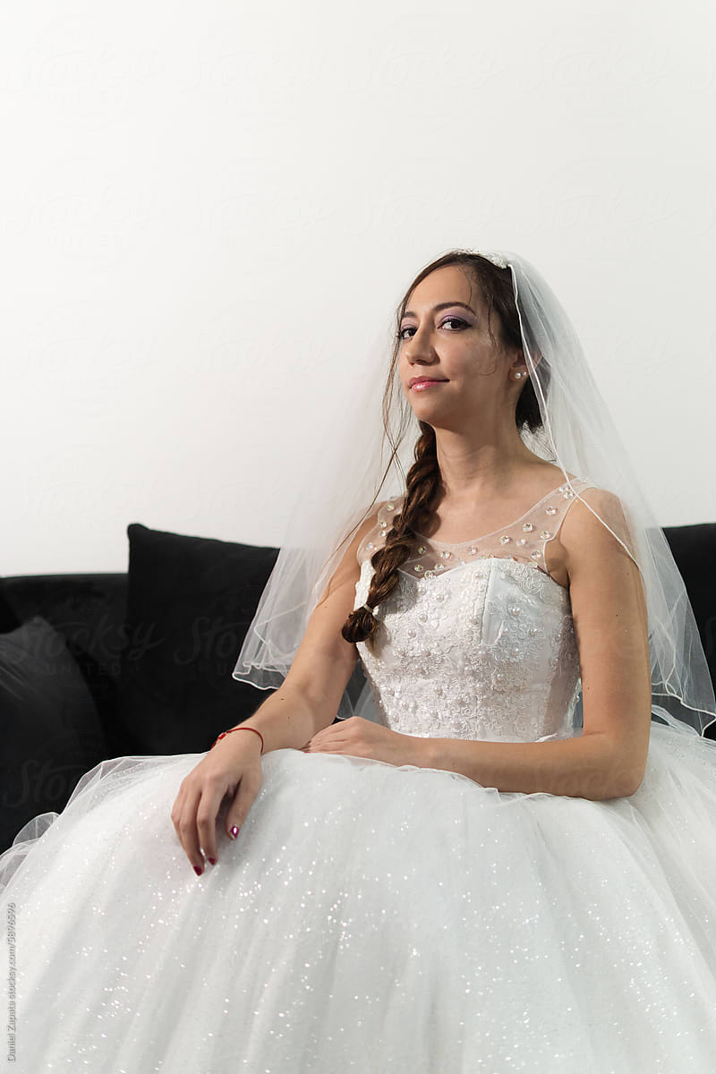 Portrait of a woman in a wedding dress looking at the camera.