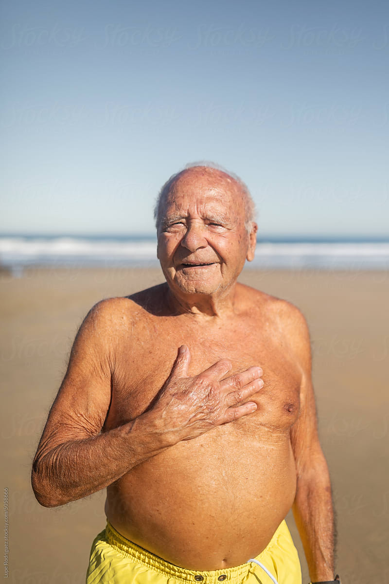 senior man in swimming trunks on the beach