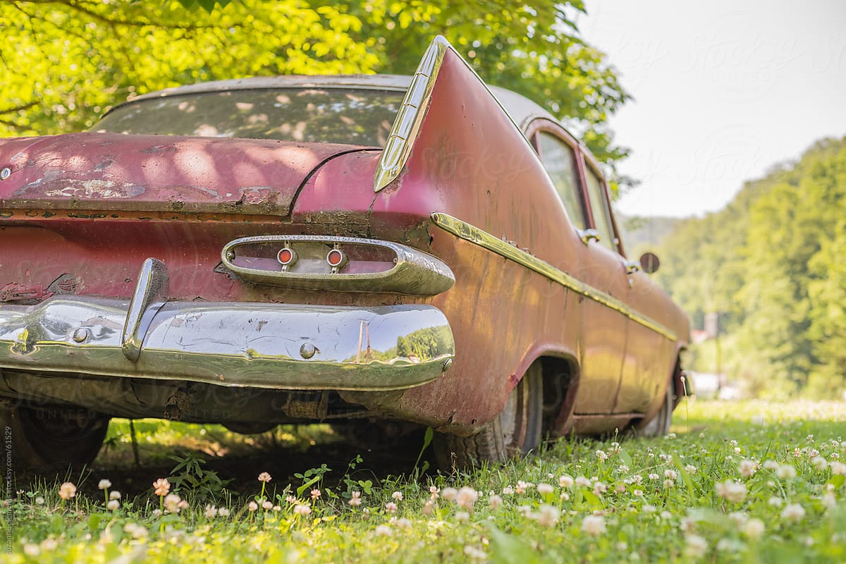 Abandoned American Car Rusts in a Field