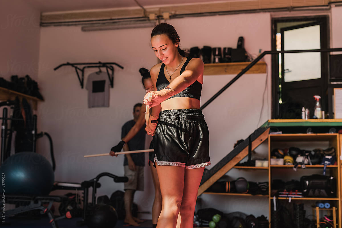 Two Female Muay Thai Athletes Warming Up With Sticks