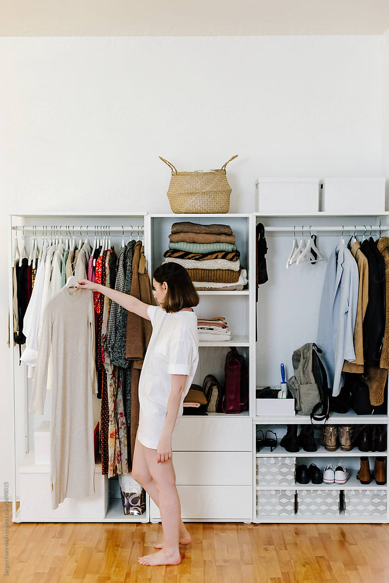 Woman choosing clothes in wardrobe