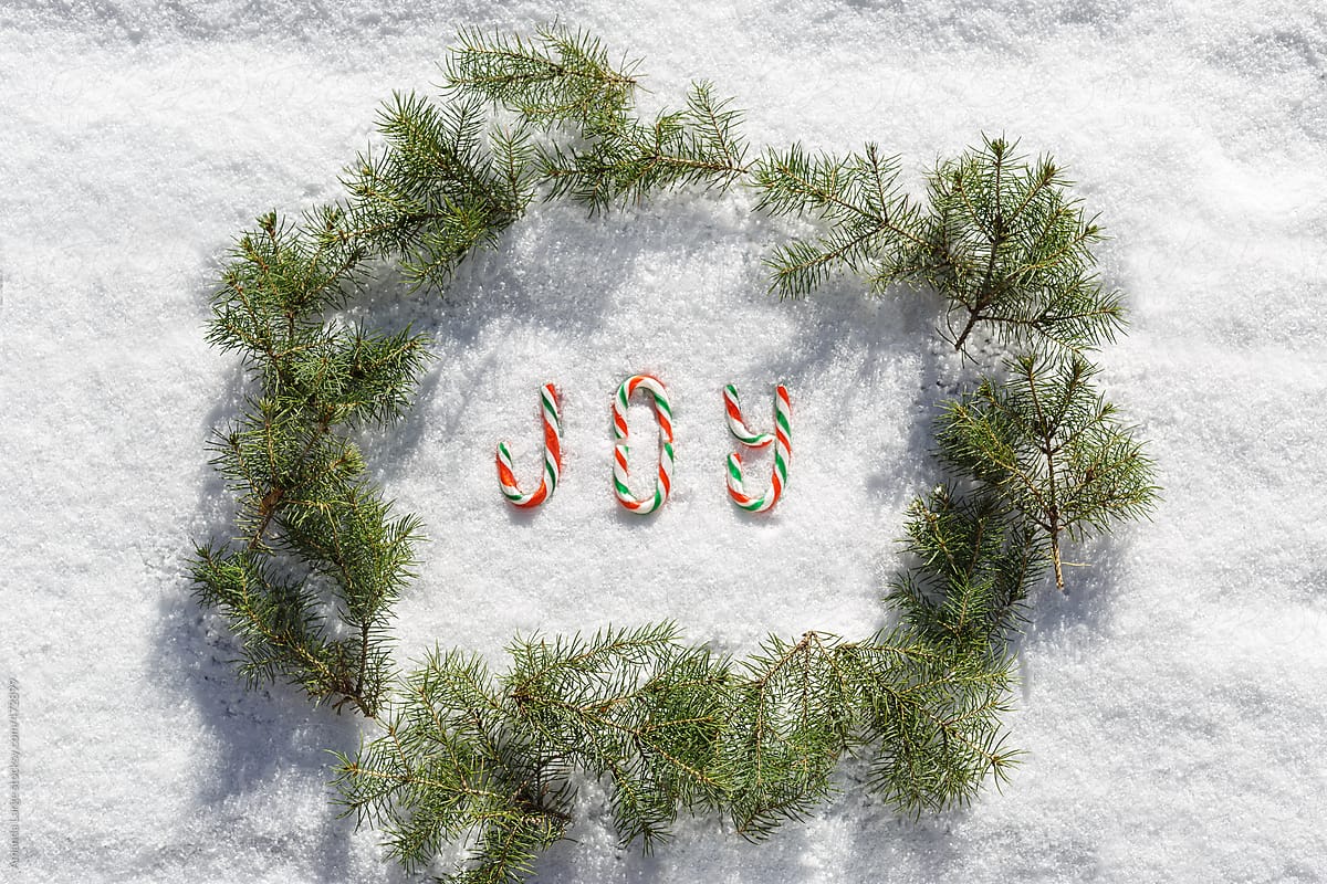 \'Joy\' written with candy canes on snow