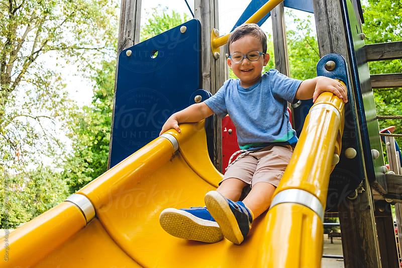 Toddler Boy on a Slide at the Playground
