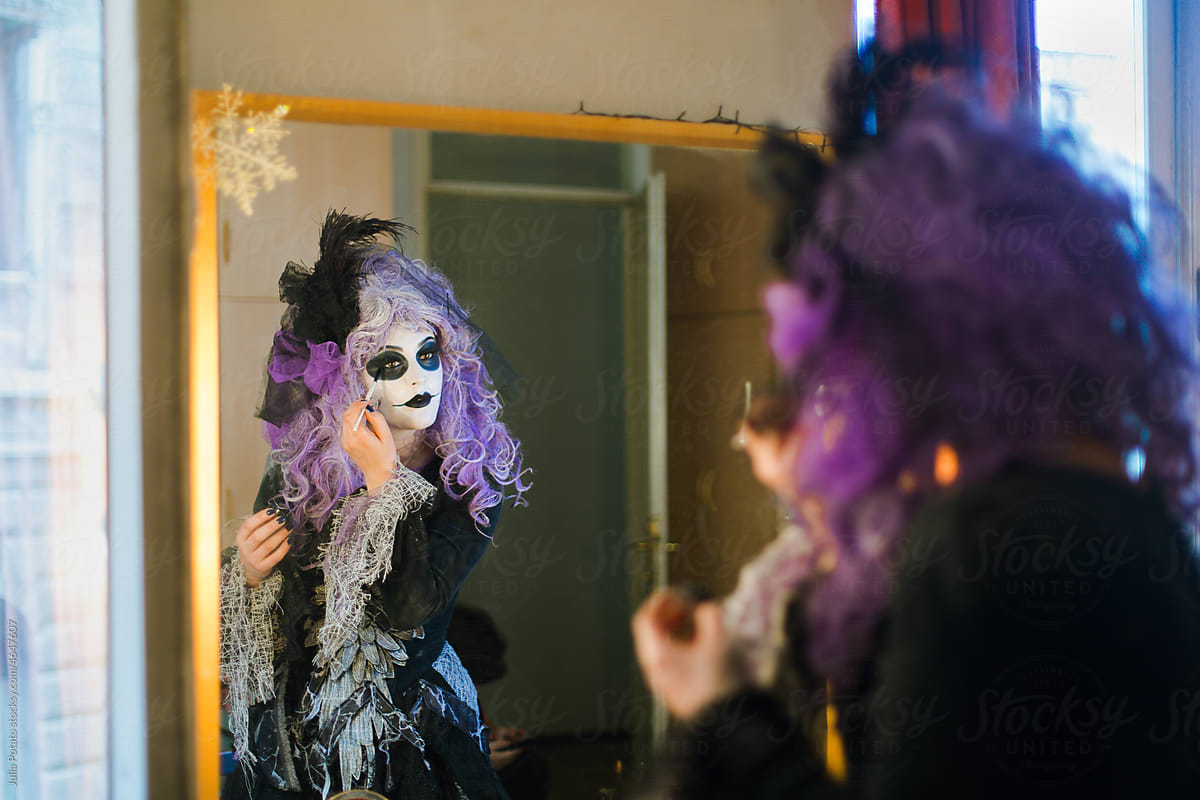 An actress  in front of a mirror makes her make-up