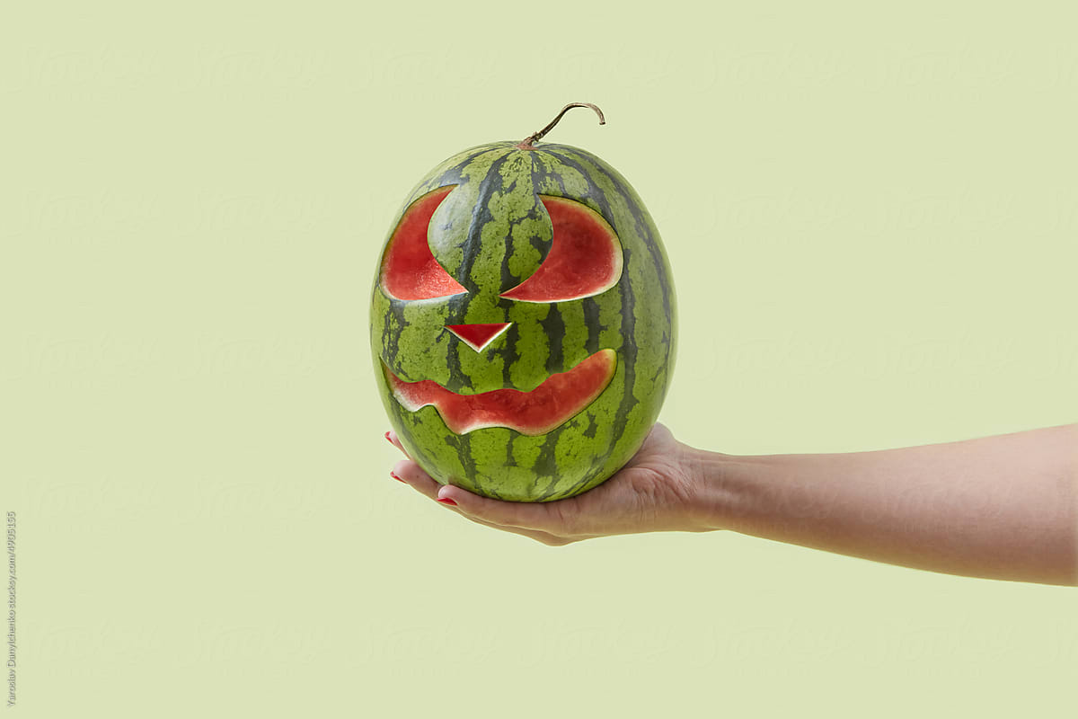 Watermelon with carved face for Halloween.