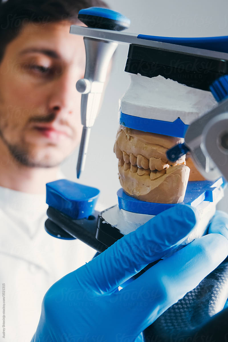 Dental Technician Making New Dental Prosthetics In Laboratory.