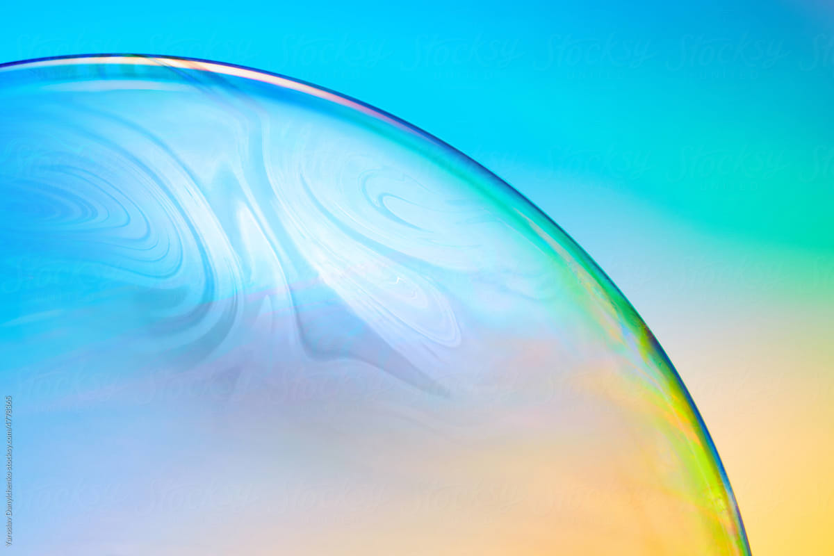 Transparent sphere on iridescent background.