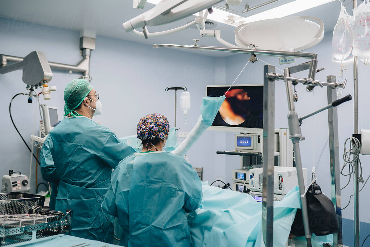 Surgeons treating shoulder of patient