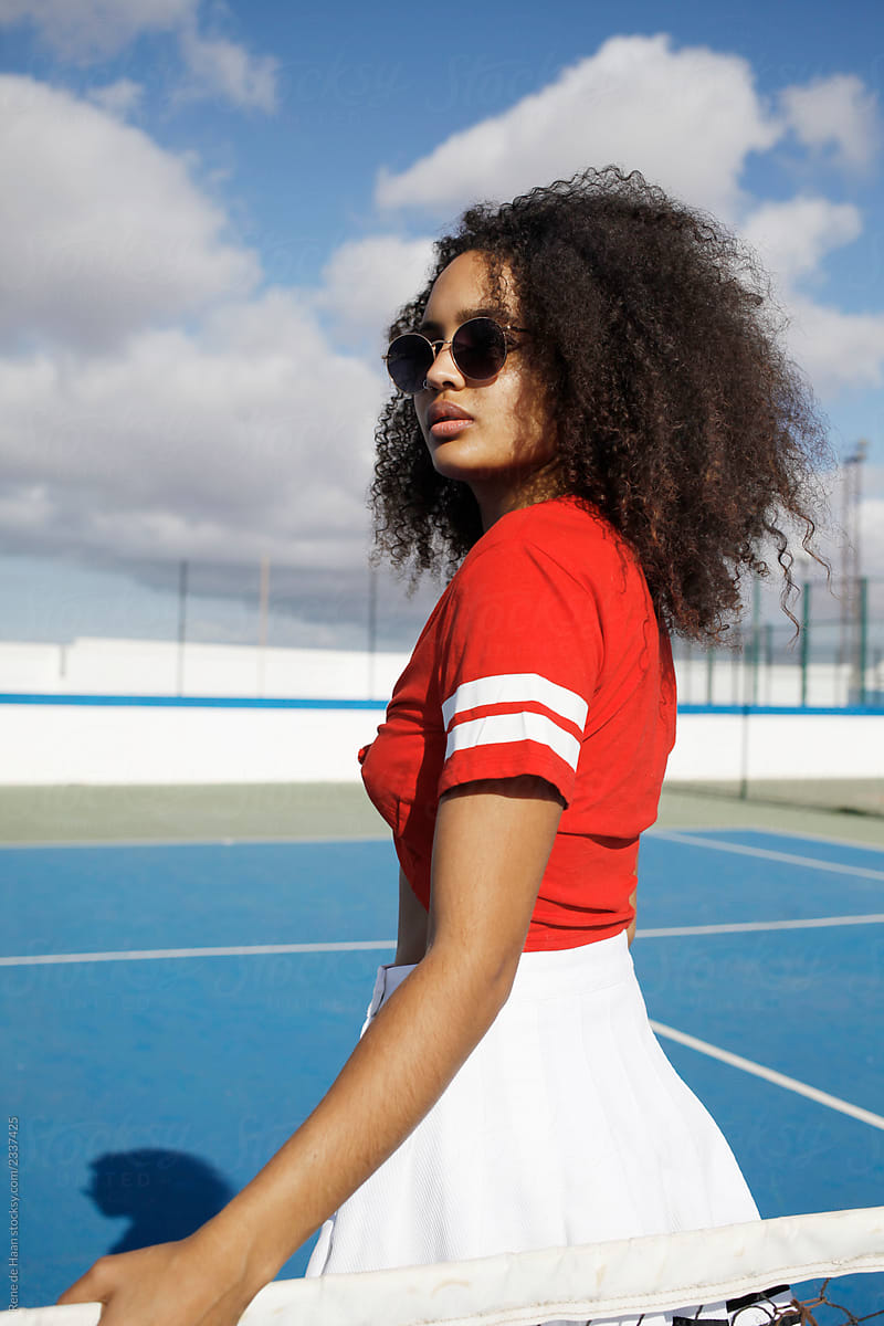 young black woman at tennis court