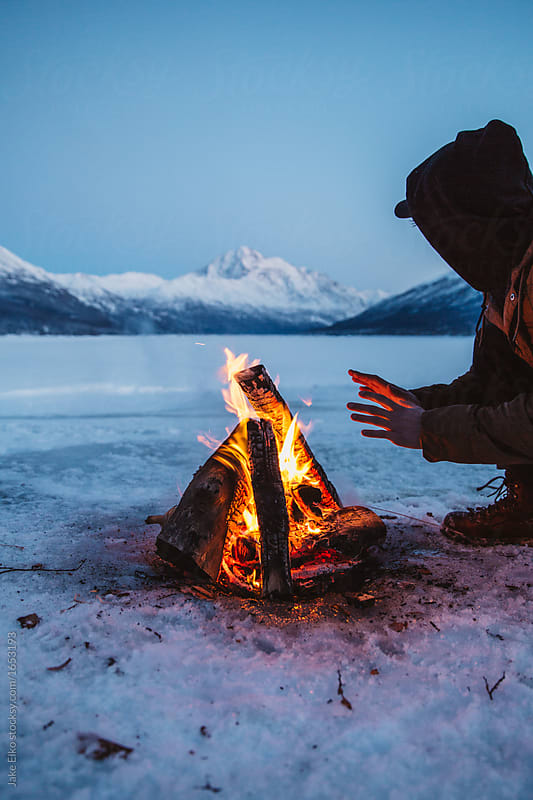 Man Near Campfire Frozen Lake Alaska