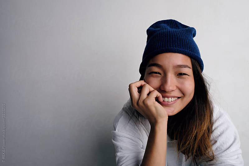Happy Korean woman in hat smiling at camera