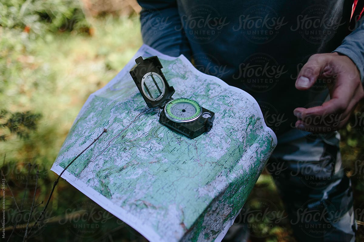 Man orienteering with the compass and map