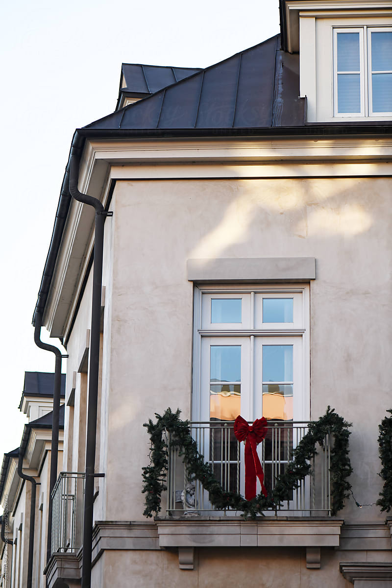 Garland And A Red Bow Hanging On A Balcony