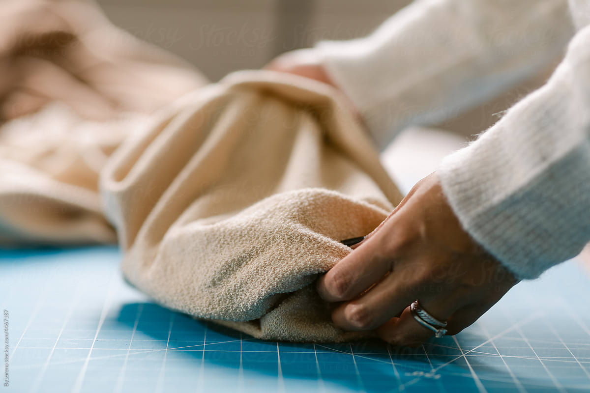 Delicate hands touching organic fabric at work