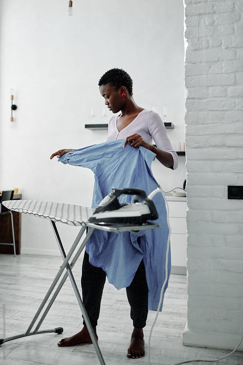Female housewife preparing apparel for ironing