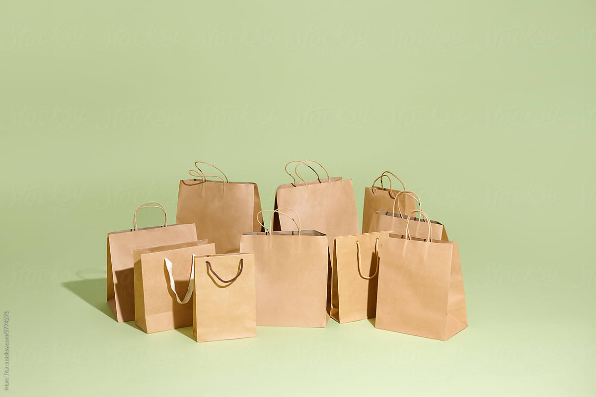 Group of craft shopping bags on a green background