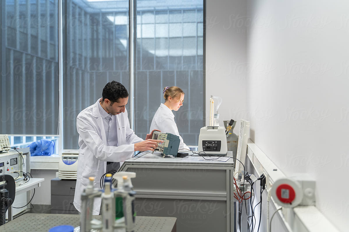 Two Scientists Working In Bioelectrics Lab Room