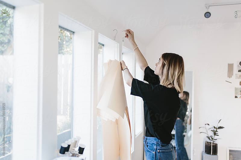 young artist woman designing clothing in studio