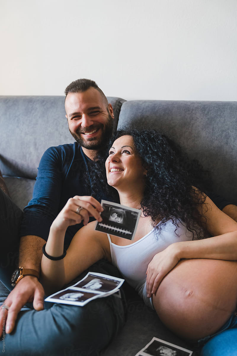 Happy Adult Couple with Baby Ultrasound Scans and Heartbeat