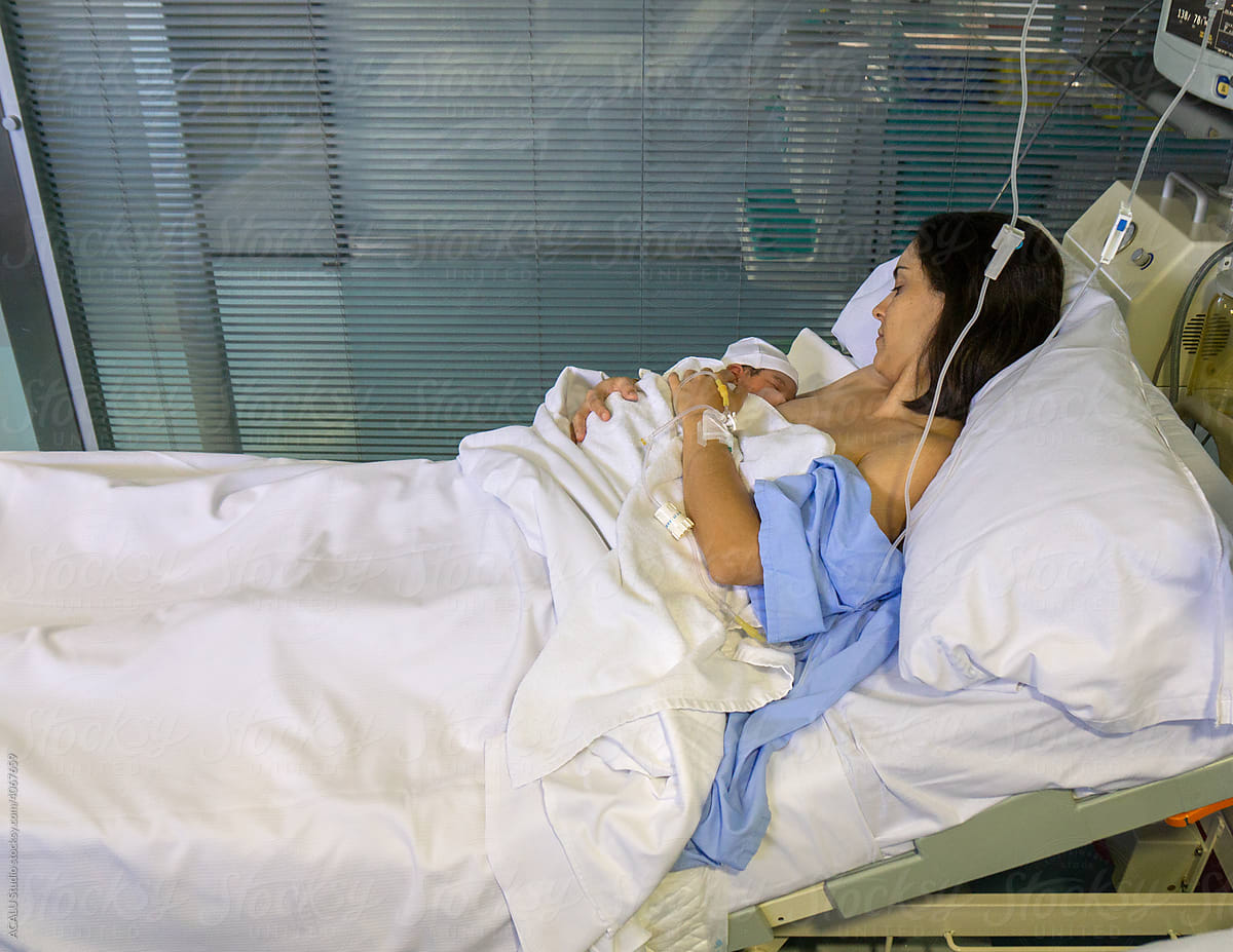 Mother Breastfeeding Newborn In Hospital