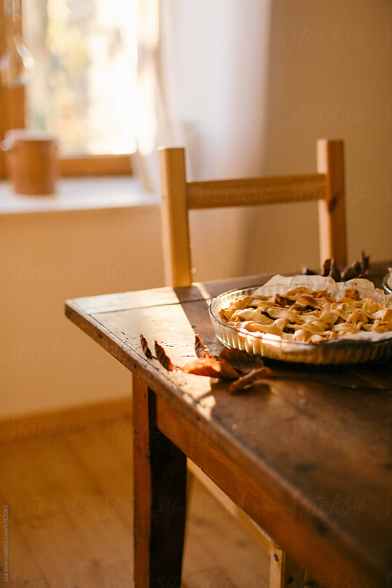 apple pie on wooden farm table in the light