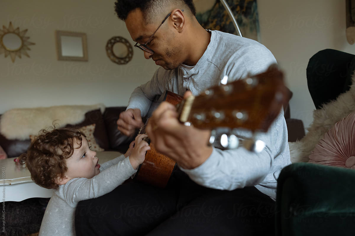 Gentle guitar lesson with young child