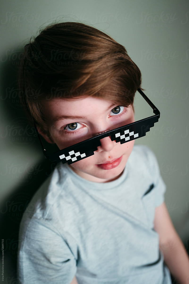 Portrait of cute boy in pixel sunglasses.