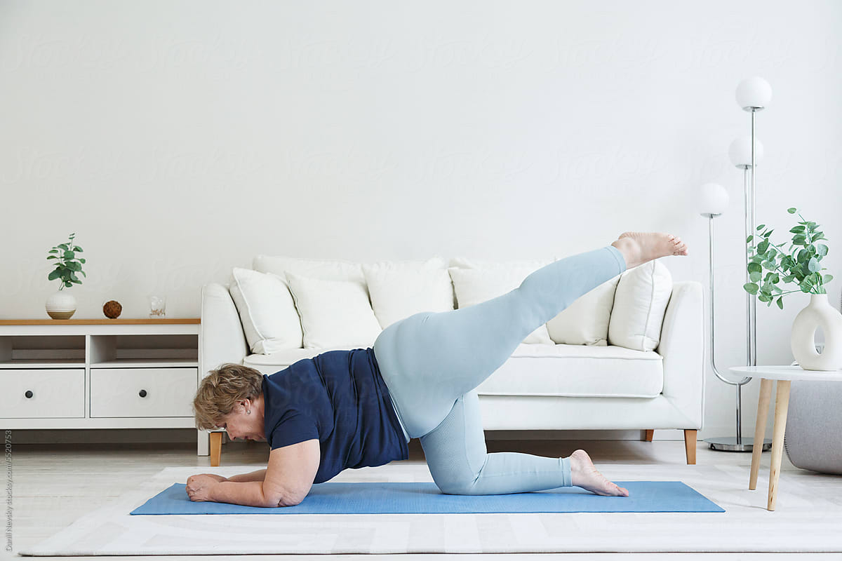 Flexible plus size woman doing forearm plank