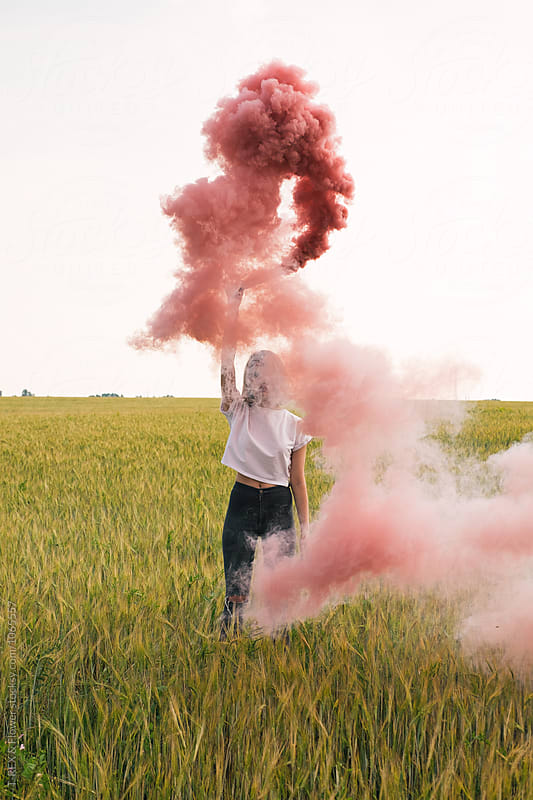 Unrecognizable girl with smoke bomb