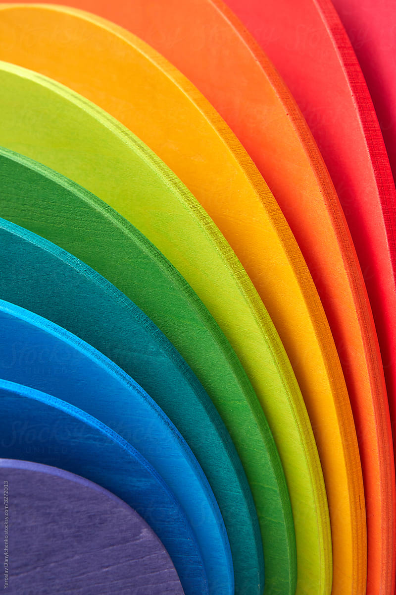 Wooden rainbow colored curved boards.