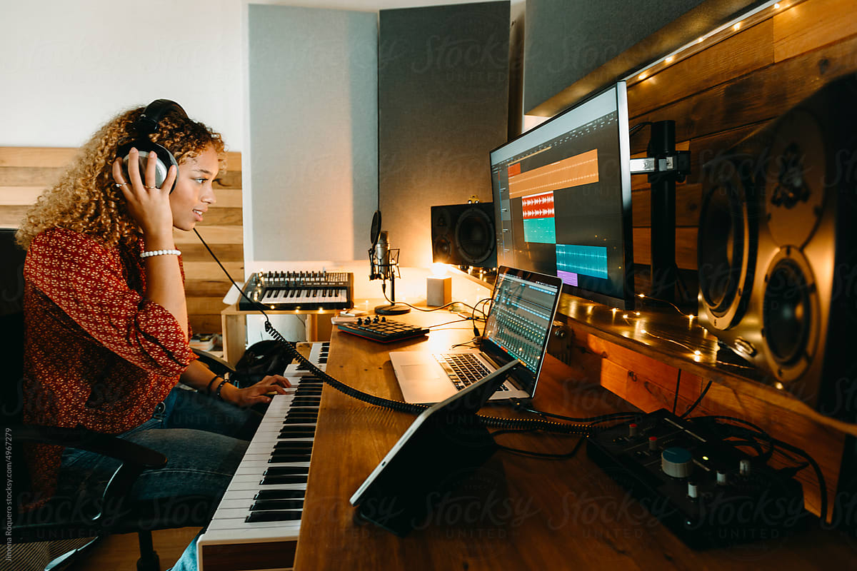 Music composer working at home studio using headphones