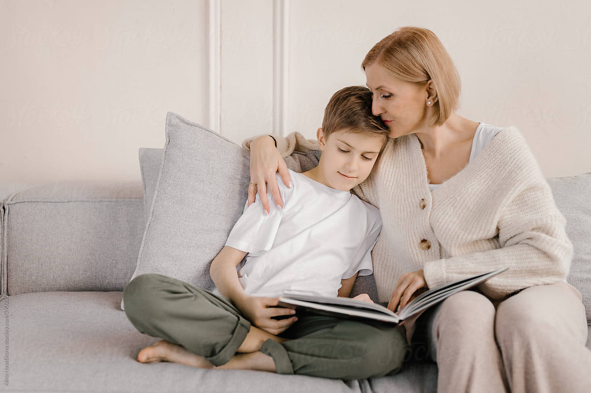 Mother and son reading book together at home