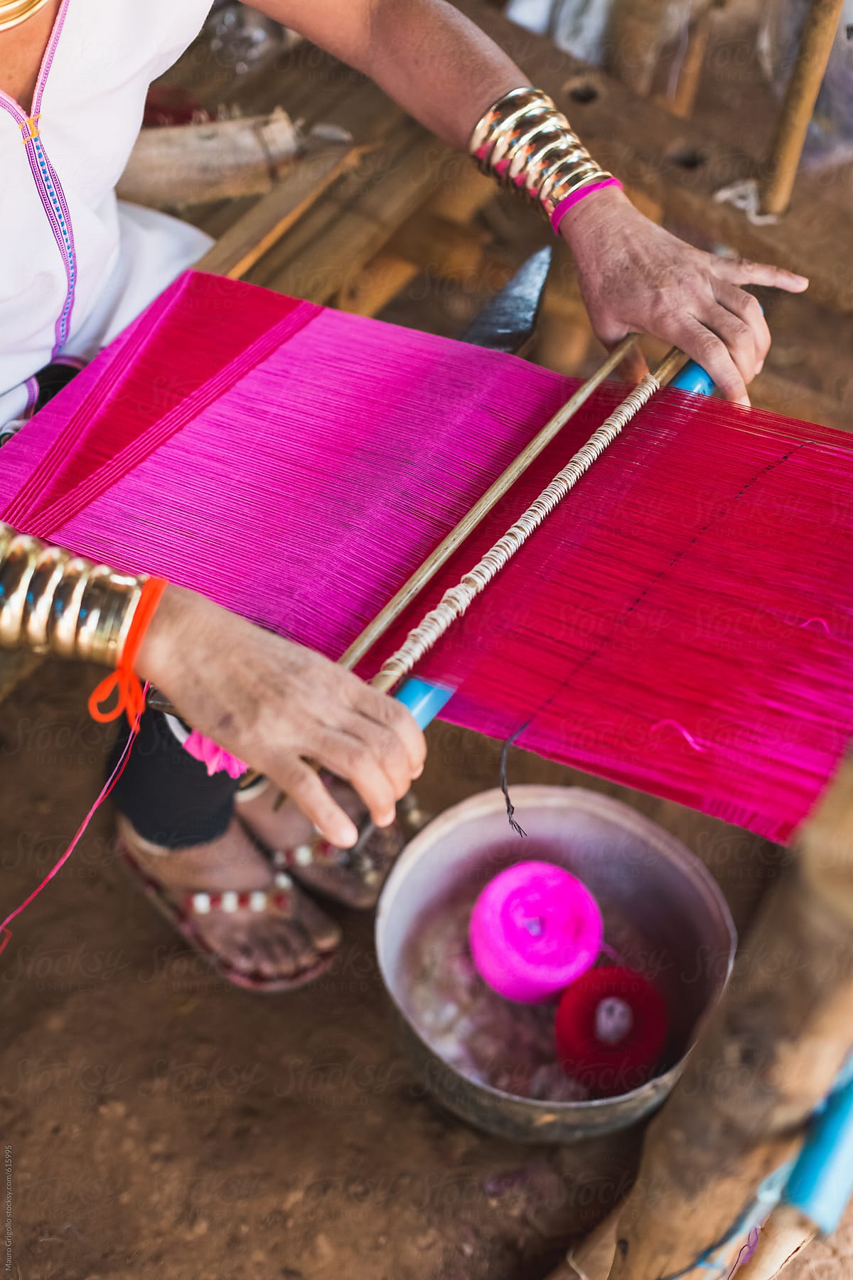 A woman works on the loom to make silk fabrics