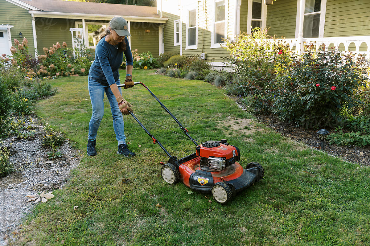 woman starting up her lawnmower