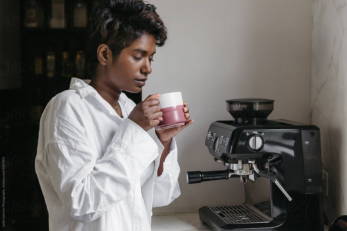 A black woman calmly enjoying a coffee at home