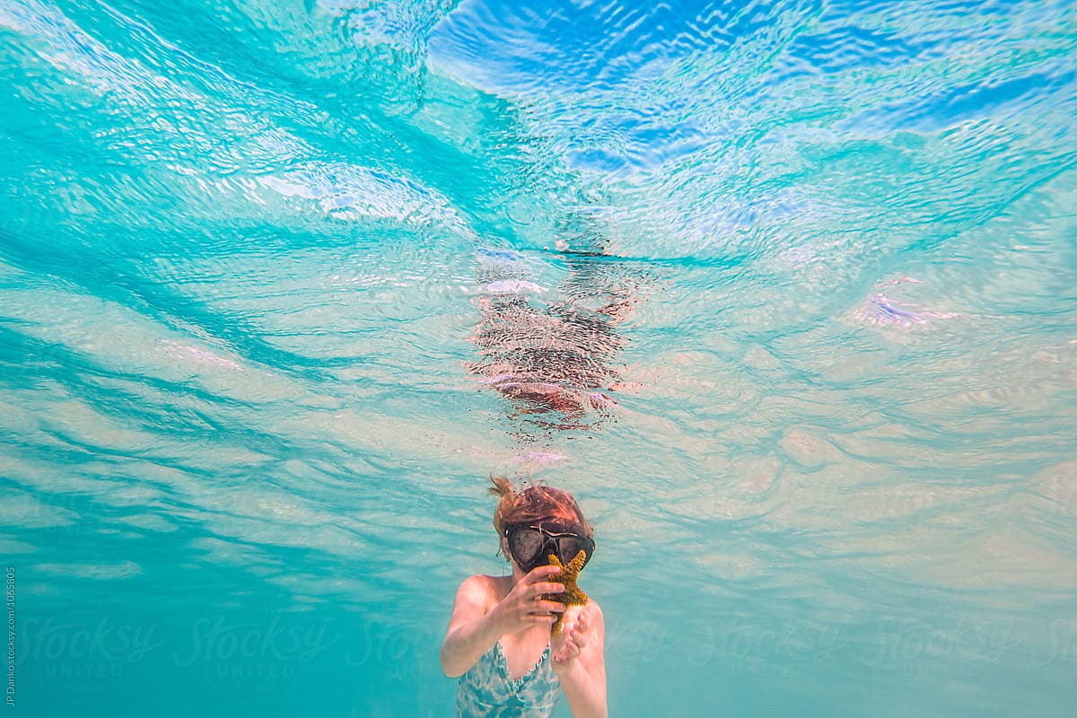 Little Girl Finding Starfish Swimming Underwater at All Inclusive Caribbean Resort White Sand Beach