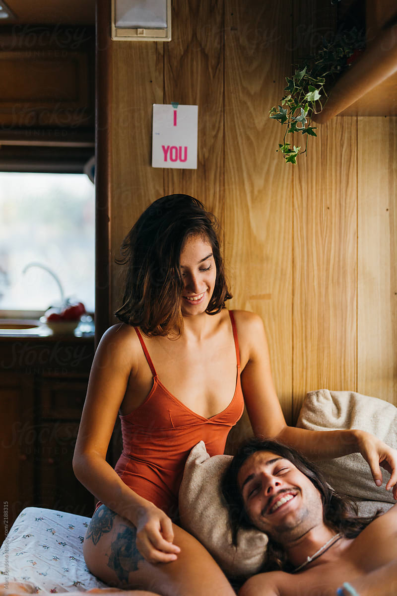 happy young couple wakig up in a motorhome
