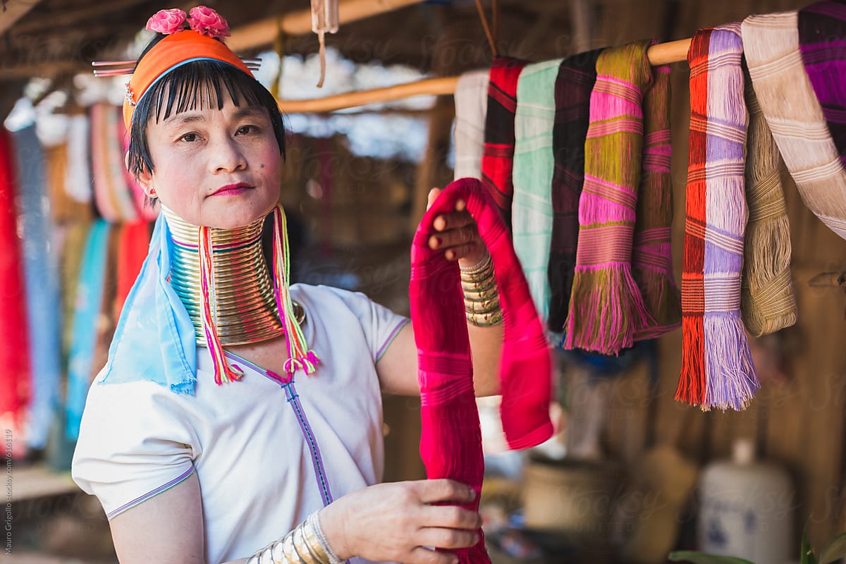 A long neck tribal woman showing silk handmade clothes