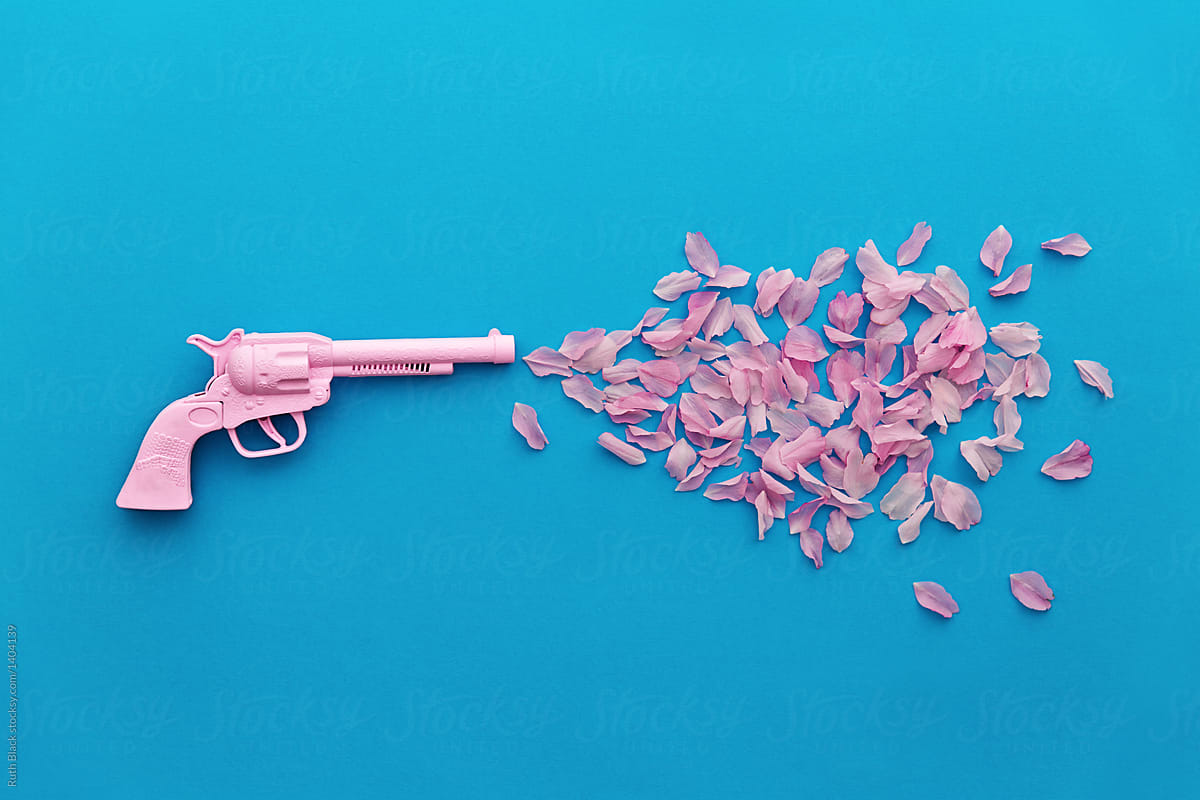 Toy gun with rose petals