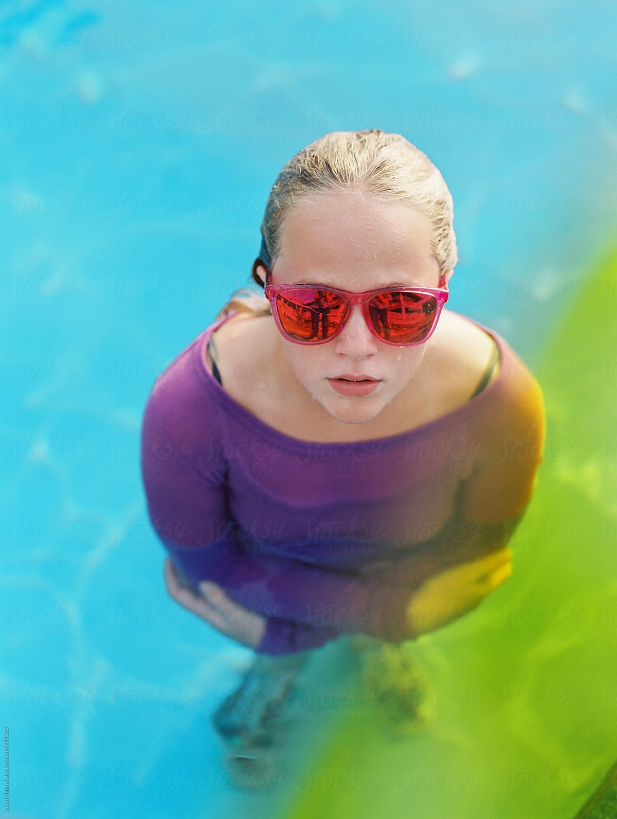Girl In Pink Sunglasses With Yellow And Green In Pool By Stocksy