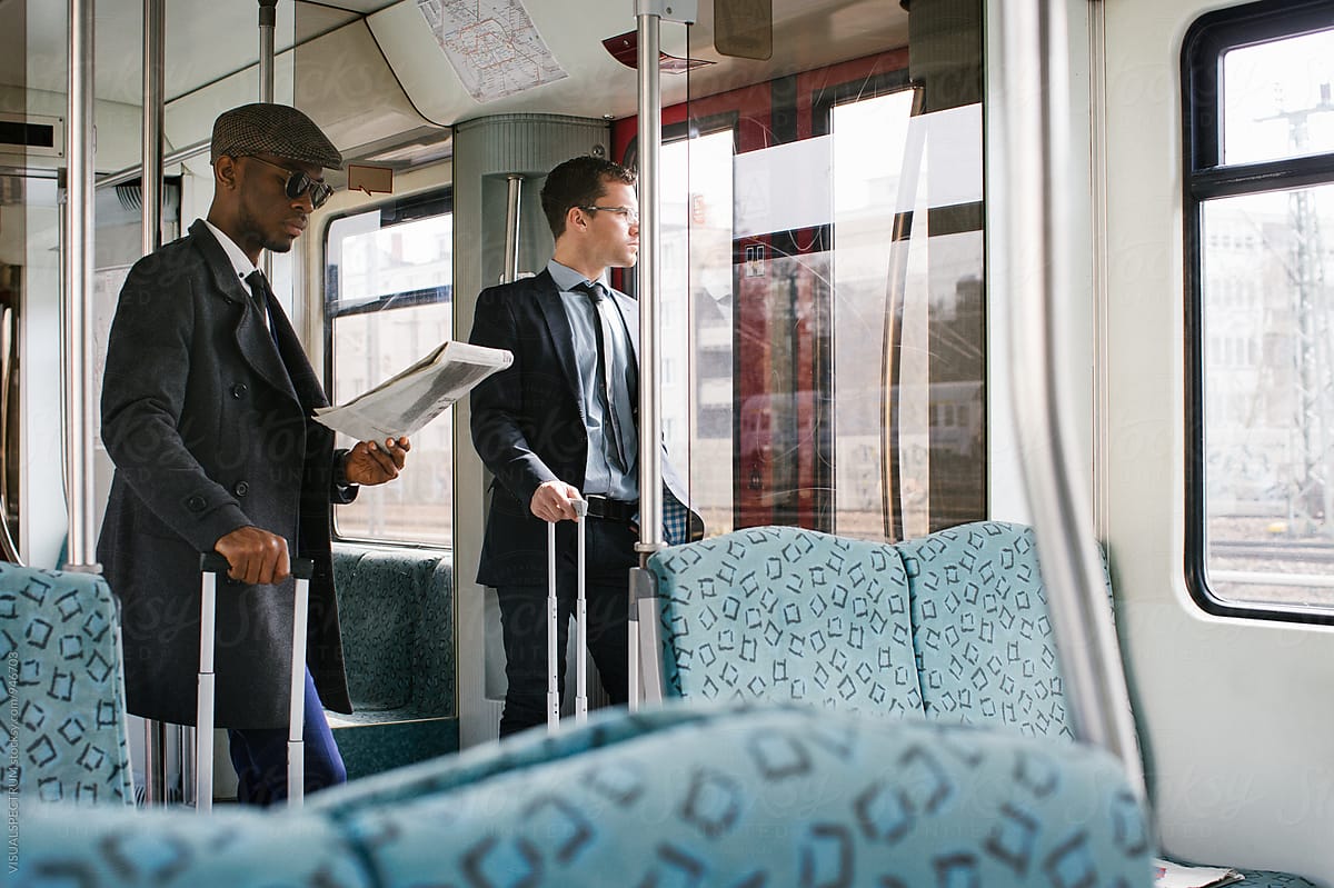 Two Business Travelers Commuting in Urban Train
