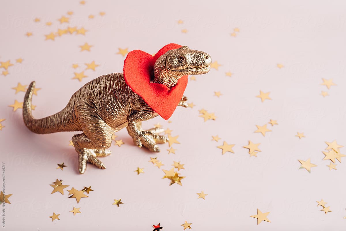Golden dino with a red heart around his neck