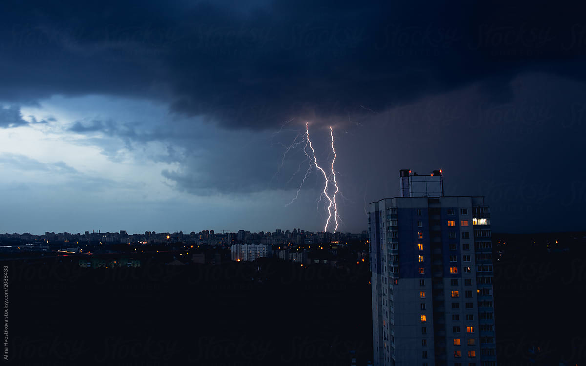 Lightning in stormy sky above dark city
