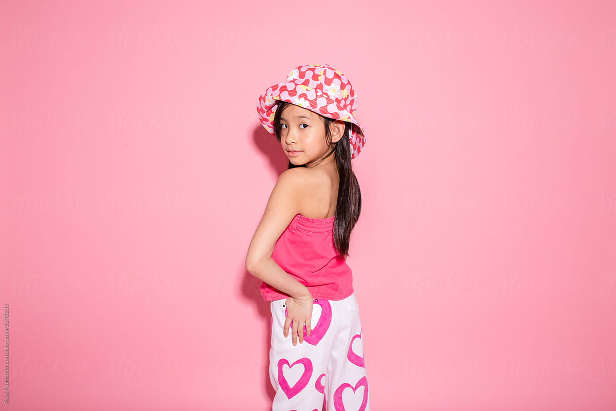 Young girl posing on pink background