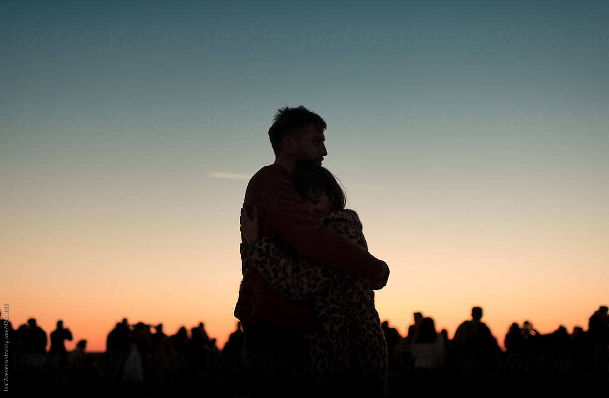 Intimate couple hug silhouette at sunset